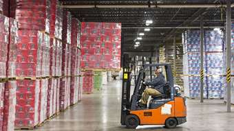 A cart drives through the interior of a warehouse