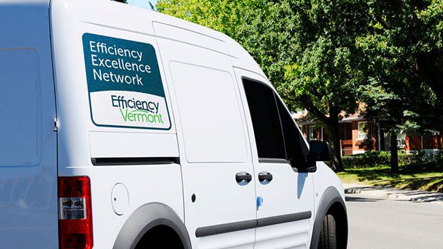 picture of a service van that has the decal for Efficiency Vermont's Efficiency Excellence Network logo on the side